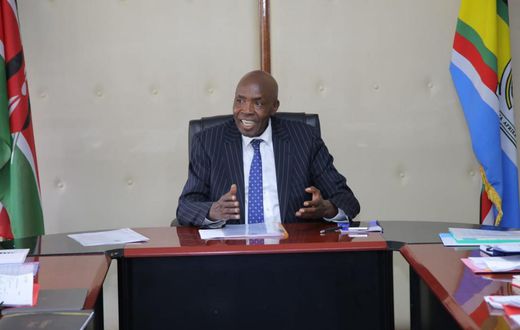 Ezekiel Machogu chairs a meeting in his office