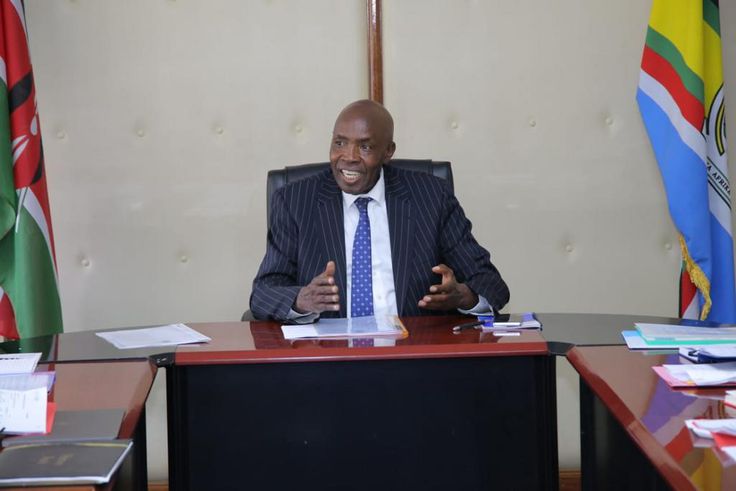 Ezekiel Machogu chairs a meeting in his office