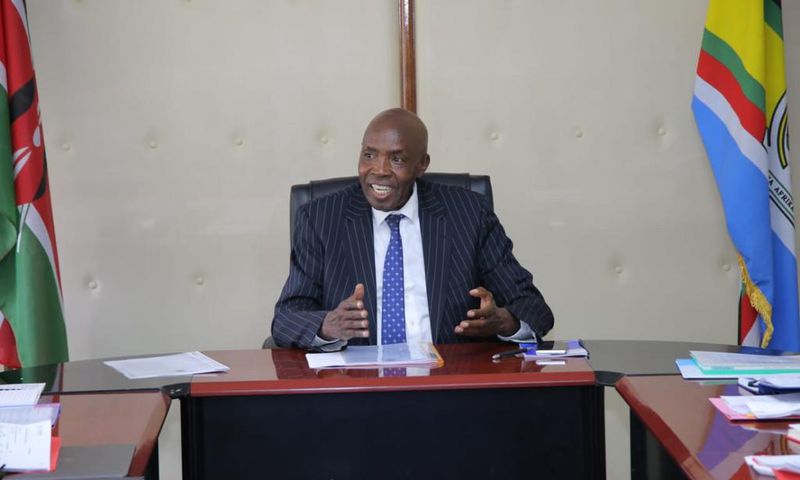 Ezekiel Machogu chairs a meeting in his office