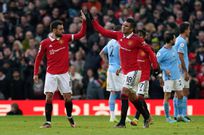 Manchester United s Bruno Fernandes celebrates with Casemiro after scoring his side's first goal to level the score at 1-1 as Manchester City players appeal to referee Stuart Attwell during the Premier League match at Old Trafford on January 14, 2023.