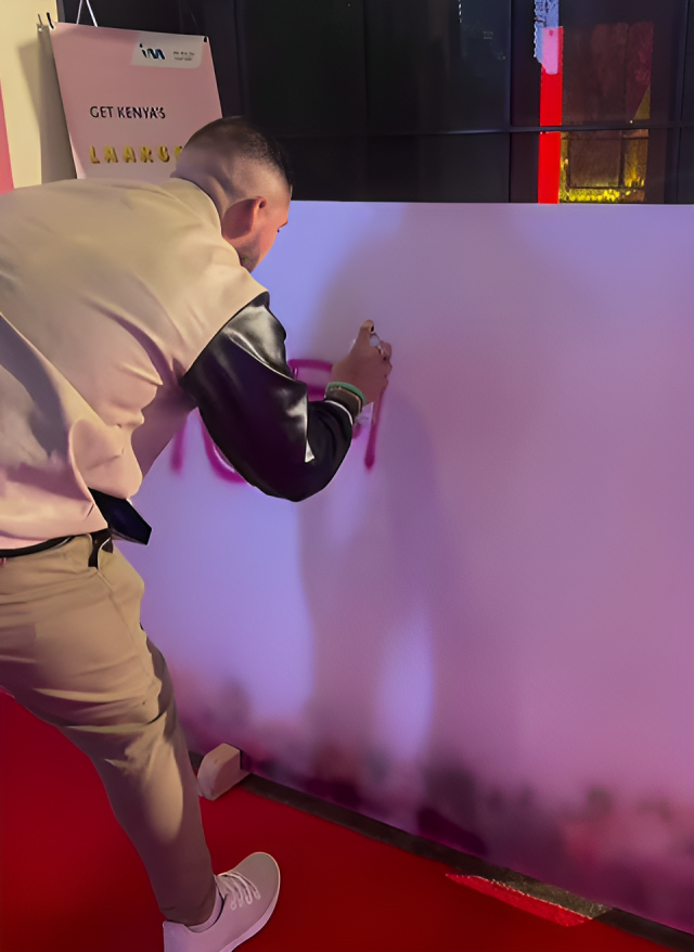 Guest participating in Kenya's most collaborative art piece, sponsored by I&M Bank at the Pulse Influencer Awards 2023