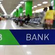 Customers are served at the Kenya Commercial Bank (KCB) in Nairobi on January 24, 2018. (Photo by SIMON MAINA/AFP via Getty Images)