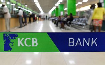 Customers are served at the Kenya Commercial Bank (KCB) in Nairobi on January 24, 2018. (Photo by SIMON MAINA/AFP via Getty Images)