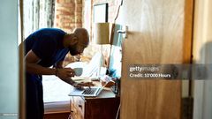 A man using a computer on dressing table