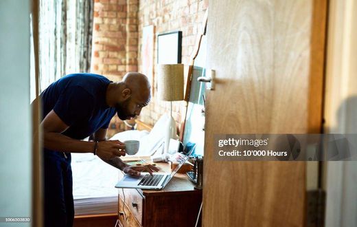 A man using a computer on dressing table