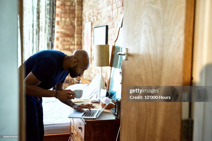 A man using a computer on dressing table