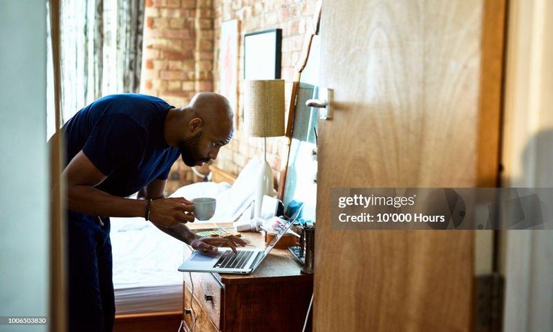 A man using a computer on dressing table