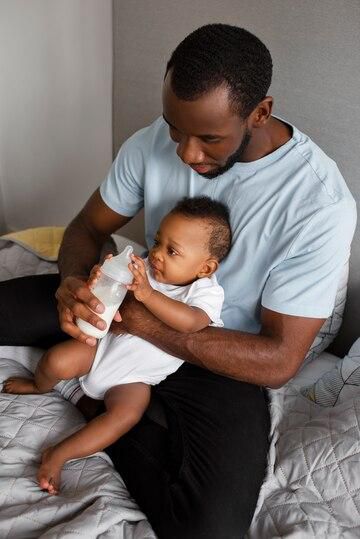 A father bonding with his baby at home