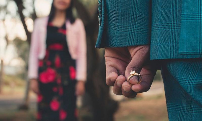A man holding an engagement ring about to propose [Photo: Jesus Arias]