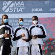 The 2021 Ostia Half Marathon women's race podium finishers Joyce Chepkemoi Tele, Betty Chepkemoi Kibet and Gloria Kite during the award ceremony