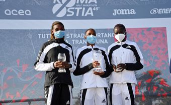 The 2021 Ostia Half Marathon women's race podium finishers Joyce Chepkemoi Tele, Betty Chepkemoi Kibet and Gloria Kite during the award ceremony