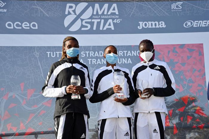 The 2021 Ostia Half Marathon women's race podium finishers Joyce Chepkemoi Tele, Betty Chepkemoi Kibet and Gloria Kite during the award ceremony
