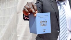 A man holding a Kenyan passport