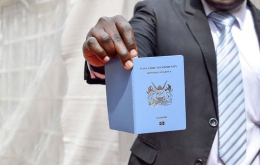 A man holding a Kenyan passport