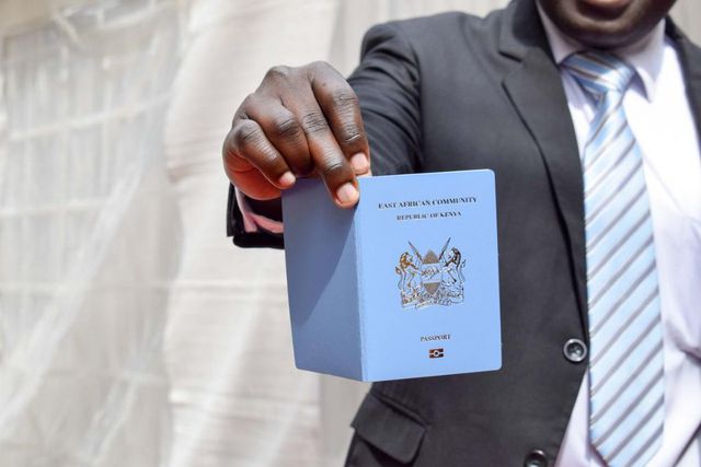 A man holding a Kenyan passport