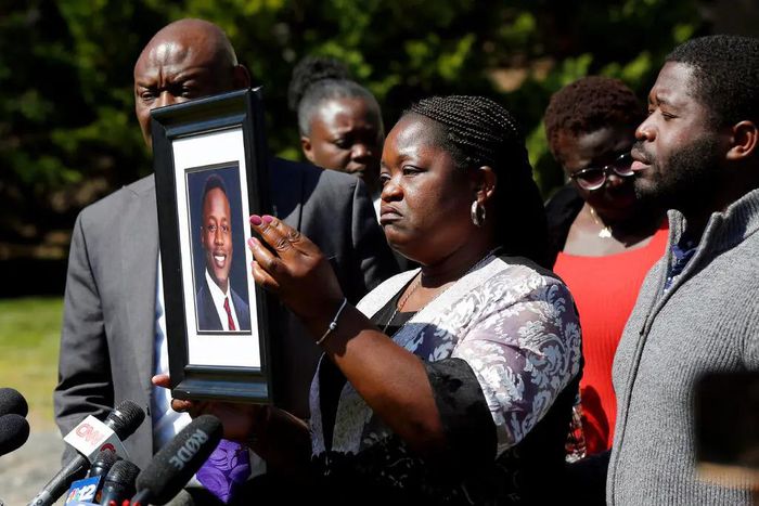Caroline Ouko, mother of Irvo Otieno, holds a portrait of her son at a news conference in March. Photo Credit: Daniel Sangjib Min/Richmond Times-Dispatch, via Associated Press