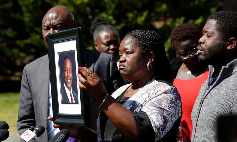 Caroline Ouko, mother of Irvo Otieno, holds a portrait of her son at a news conference in March. Photo Credit: Daniel Sangjib Min/Richmond Times-Dispatch, via Associated Press