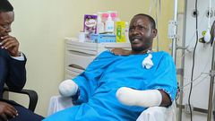 Tourism CS Alfred Mutua at Nairobi West hospital when he visited police officer David Karuri Maina who lost both arms after a teargas canister exploded during the anti-finance bill protests