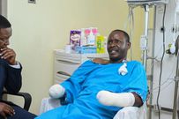 Tourism CS Alfred Mutua at Nairobi West hospital when he visited police officer David Karuri Maina who lost both arms after a teargas canister exploded during the anti-finance bill protests