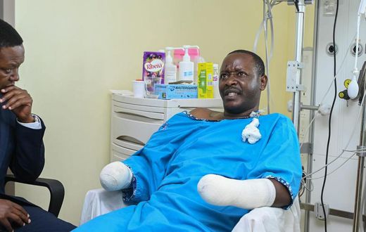 Tourism CS Alfred Mutua at Nairobi West hospital when he visited police officer David Karuri Maina who lost both arms after a teargas canister exploded during the anti-finance bill protests