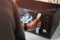 A man using a microwave