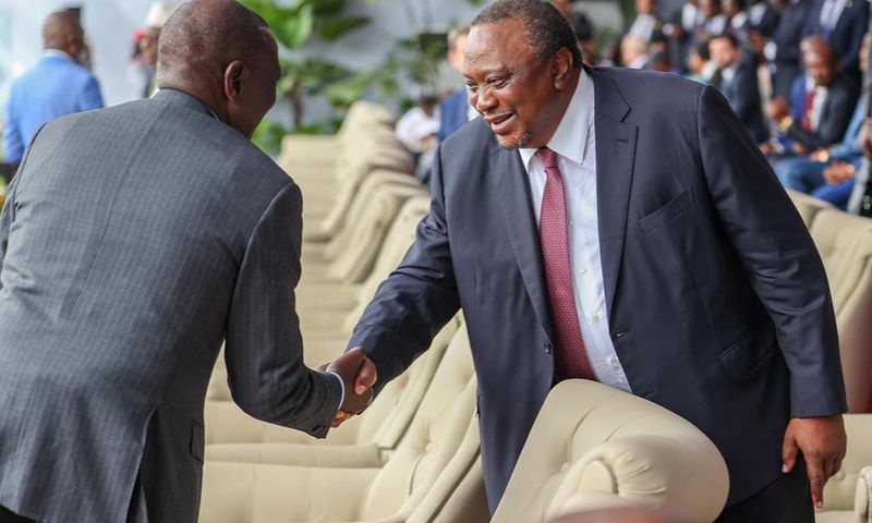President William Ruto shaking hands with his predecessor, retired President Uhuru Kenyatta in Kinshasa