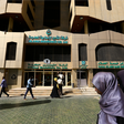 People walk past the Faisal Islamic Bank in Khartoum, Sudan January 12, 2016.