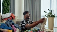 A man folding clothes