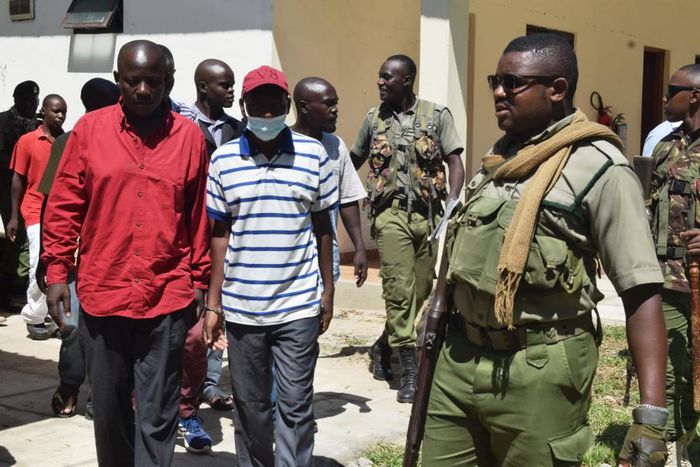 Paul Mackenzie escorted by police officers