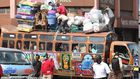 Bus attendants help fasten wares to the top of a matatu at the Machakos Country Bus Station [Photo: Steve MulwawaKi7]