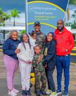 Samidoh Muchoki, Edday Nderitu and their children pose for a photo at the airport before embarking on their vacation