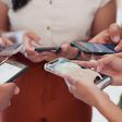 A photo of people using their phones