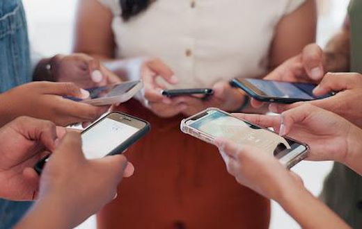 A photo of people using their phones