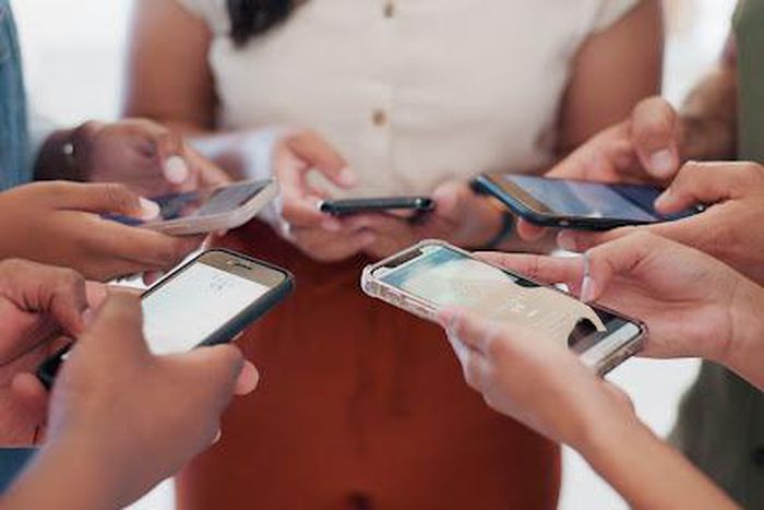 A photo of people using their phones