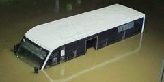 A minibus partially submerged in water at Jomo Kenyatta International Airport (JKIA) as floods wreak havoc in Kenya
