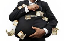Stock image of a businessman holding black bag full of Kenyan shilling notes