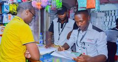 A KRA Revenue Service Assistant RSA attending to a businessman in Nairobi