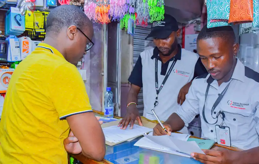 A KRA Revenue Service Assistant RSA attending to a businessman in Nairobi