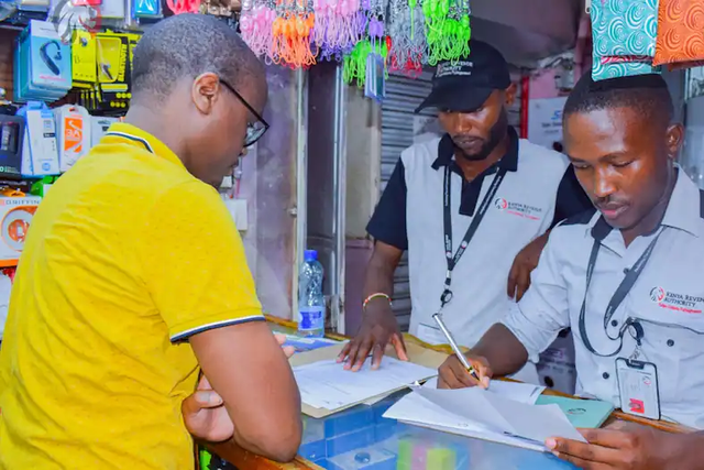 A KRA Revenue Service Assistant RSA attending to a businessman in Nairobi