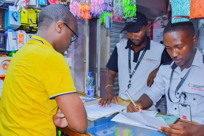A KRA Revenue Service Assistant RSA attending to a businessman in Nairobi