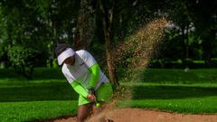 Golfer taking a shot from a sand trap