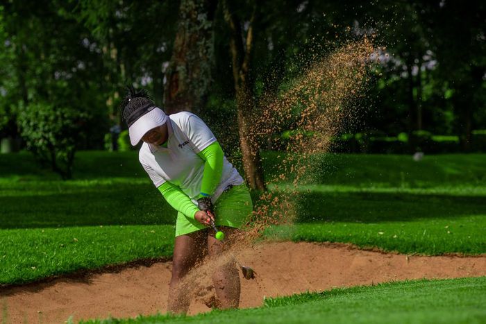 Golfer taking a shot from a sand trap