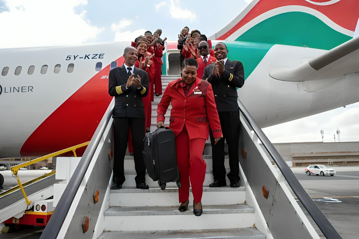 Retired KQ staffer Alice Waweru alights from a KQ plane on her last day of working after serving the company for 38 years.
