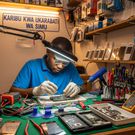 An AI-generated image of a technician working at an electronics repair shop