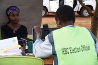 A voter's biometric information is captured by an IEBC official