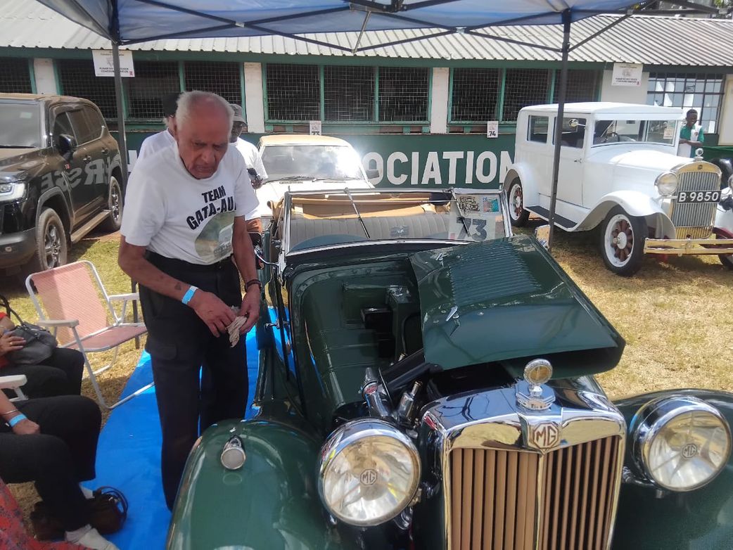 Concours d'Elegance 2025 winner Sati Gata-Aura cleans his car ahead of the competition