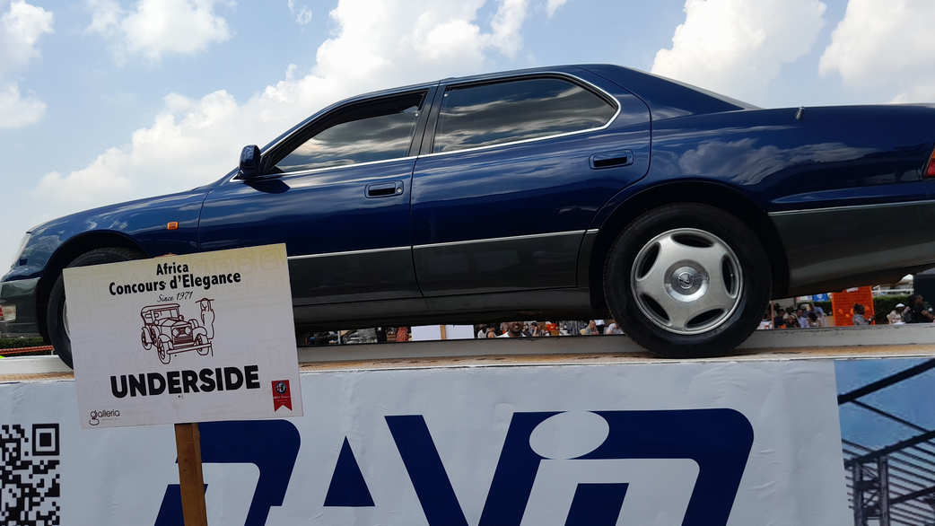 The car is hoisted several feet into the air for the underside inspection