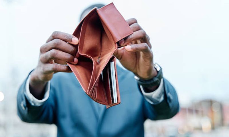 A person showing their wallet