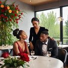 An AI-generated image of a lady and a man in a restaurant (HotPot.ai)