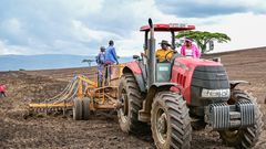 President William Ruto driving a tractor while preparing land for the planting season